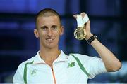 16 August 2013; Ireland's Robert Heffernan with his men's 50k walk gold medal in Dublin airport on his return from the IAAF World Athletics Championships in Moscow. Dublin Airport, Dublin. Photo by Sportsfile