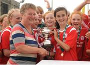 17 August 2013; Alex Kavanagh, Shelbourne, is presented with the cup by Niamh O'Donoghue, Chairperson WFAI. FAI Umbro U14 Women's Cup Final, Peamount United v Shelbourne, Oscar Traynor Centre, Coolock, Dublin. Picture credit: Pat Murphy / SPORTSFILE