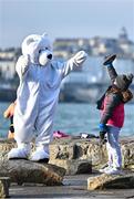 10 December 2022; People get freezin’ for a reason to support Special Olympics Ireland as the organisation raises funds to send over 70 athletes to the World Games in Berlin 2023. The Polar Plunge mascot with a young supporter during the Special Olympics Ireland Polar Plunge at Sandycove Beach in Dublin. Photo by Eóin Noonan/Sportsfile