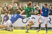 17 December 2022; Henry McErlean of Ireland evades the tackle of Tommaso Simoni of Italy, left, on his way to score his side's fourth try during the U20 Rugby International Friendly match between Ireland and Italy at Clontarf RFC in Dublin. Photo by Sam Barnes/Sportsfile