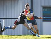 19 January 2023; Alex Gallagher of St Fintan's High School is tackled by Fionn Whelan of Ardscoil na Tríonóide during the Bank of Ireland Fr Godfrey Cup Second Round match between St Fintan's High School and Ardscoil na Tríonóide at Old Belvedere RFC in Dublin. Photo by Harry Murphy/Sportsfile