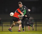 25 January 2023; Queen's University Belfast goalkeeper Brian Cassidy is tackled by Fionn Herlihy of UCC during the HE GAA Sigerson Cup Round 3 match between University College Cork and Queen's University Belfast at the GAA National Games Development Centre in Abbotstown, Dublin. Photo by Piaras Ó Mídheach/Sportsfile