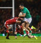 4 February 2023; James Lowe of Ireland is tackled by Taulupe Faletau, left, and Scott Baldwin during the Guinness Six Nations Rugby Championship match between Wales and Ireland at Principality Stadium in Cardiff, Wales. Photo by David Fitzgerald/Sportsfile