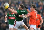 5 February 2023; Matthew Ruane of Mayo attempts to gather possession under pressure from Barry McCambridge of Armagh during the Allianz Football League Division 1 match between Armagh and Mayo at Box-It Athletic Grounds in Armagh. Photo by Brendan Moran/Sportsfile