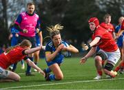 16 February 2023; Robyn O'Connor of Leinster dives over to score her side's third try despite the tackle of Fia Whelan, left, and Beth Buttimer of Munster during the U18 Girls Interprovincial match between Leinster and Munster at Terenure College in Dublin. Photo by Harry Murphy/Sportsfile