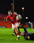 17 February 2023; Paddy Patterson of Munster breaks away from Luke Morgan of Ospreys on his way to scoring his side's fifth try during the United Rugby Championship match between Munster and Ospreys at Thomond Park in Limerick. Photo by Sam Barnes/Sportsfile