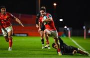 17 February 2023; Paddy Patterson of Munster breaks away from Luke Morgan of Ospreys on his way to scoring his side's fifth try during the United Rugby Championship match between Munster and Ospreys at Thomond Park in Limerick. Photo by Sam Barnes/Sportsfile