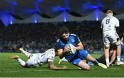 18 February 2023; Harry Byrne of Leinster scores his side's fourth try despite the tackle of Ashton Hewitt of Dragons during the United Rugby Championship match between Leinster and Dragons at RDS Arena in Dublin. Photo by Harry Murphy/Sportsfile