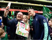 2 March 2023; Jonathan Sexton takes a selfie with Elle Travers, aged five, from Naas, Kildare, and her father Alan during an Ireland Rugby open training session at the Aviva Stadium in Dublin. Photo by Harry Murphy/Sportsfile