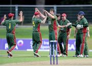 24 August 2013; Merrion's Simon Morrissey, third from left, celebrates with team-mates after bowling Clontarf's Dom Rigby an LBW for 28 runs. RSA Irish Senior Cup Final, International Stadium, Malahide, Co. Dublin. Picture credit: Brian Lawless / SPORTSFILE