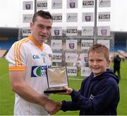 24 August 2013; Adam Griffiths, aged 11, from Narraghmore, Co. Kildare, presents the Man of the Match award to Antrim's Stephan McAfee. Bord Gáis Energy GAA Hurling Under 21 All-Ireland Championship Semi-Final, Wexford v Antrim, Semple Stadium, Thurles, Co. Tipperary. Picture credit: Ray McManus / SPORTSFILE
