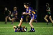 25 March 2023; Lily Clifford of Presentation Secondary School Milltown gives assistance to teammate Éabha O'Callaghan during the Lidl LGFA Post Primary Junior C Final match between Dunmore Community School, Galway, and Presentation Secondary School Milltown, Kerry at Fethard Town Park in Tipperary. Photo by Michael P Ryan/Sportsfile