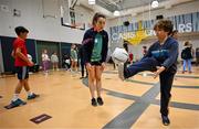 6 April 2023; Aishling O'Connell of Kerry with fifth grade students during a Ladies Football coaching clinic at the Casis Elementary School during the 2023 TG4 LGFA All-Star Tour to Austin in Texas, USA. Photo by Brendan Moran/Sportsfile