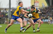 9 April 2023; Jack Coyne of Mayo is tackled by Diarmuid Murtagh, left, and Ben O'Carroll of Roscommon during the Connacht GAA Football Senior Championship Quarter-Final match between Mayo and Roscommon at Hastings Insurance MacHale Park in Castlebar, Mayo. Photo by Ramsey Cardy/Sportsfile