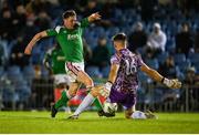 14 April 2023; Cian Murphy of Cork City in action against UCD goalkeeper Kian Moore during the SSE Airtricity Men's Premier Division match between UCD and Cork City at UCD Bowl in Dublin. Photo by Stephen Marken/Sportsfile