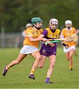 22 April 2023; Aisling Goggins of Wexford in action against Eobha McAlister of Antrim during the Electric Ireland Camogie Minor A Shield Semi-Final match between Antrim and Wexford at Coralstown Kinnegad GAA in Westmeath. Photo by Stephen Marken/Sportsfile