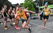 23 April 2023; Ieuan Hopkins of Brothers Pearse AC, Dublin, left, takes over from team-mate Eddie O'Connor whilst competing in the senior men's event during the 123.ie National Road Relay Championships at Raheny in Dublin. Photo by Sam Barnes/Sportsfile