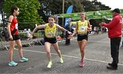 23 April 2023; Susie Nestor of UCD AC, Dublin, left, takes over from team-mate Ellie Harnett whilst competing in the senior women's event during the 123.ie National Road Relay Championships at Raheny in Dublin. Photo by Sam Barnes/Sportsfile