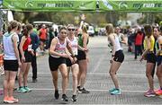 23 April 2023; Kathryn Gibbons of Crusaders AC, Dublin, left, takes over from team-mate Claire Mooney whilst competing in the senior women's event during the 123.ie National Road Relay Championships at Raheny in Dublin. Photo by Sam Barnes/Sportsfile