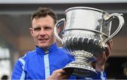 25 April 2023; Jockey Paul Townend with the trophy after riding Energumene to win the William Hill Champion Steeplechase during day one of the Punchestown Festival at Punchestown Racecourse in Kildare. Photo by Harry Murphy/Sportsfile