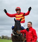27 April 2023; Jockey Paul Townend celebrates on Klassical Dream, with groom David Porter, after winning the Ladbrokes Champion Stayers Hurdle during day three of the Punchestown Festival at Punchestown Racecourse in Kildare. Photo by Seb Daly/Sportsfile