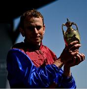 28 May 2023; Jockey Ryan Moore with the Gold cup after winning the Tattersalls Gold cup on Luxembourg during the Tattersalls Irish Guineas Festival at The Curragh Racecourse in Kildare. Photo by David Fitzgerald/Sportsfile