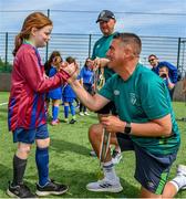 18 June 2023; FAI regional development officer Marc Kenny presents medals to players after the Football For All National Blitz on the Sport Ireland Campus in Dublin. Photo by Seb Daly/Sportsfile