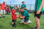 18 June 2023; FAI regional development officer Marc Kenny presents medals to players after the Football For All National Blitz on the Sport Ireland Campus in Dublin. Photo by Seb Daly/Sportsfile