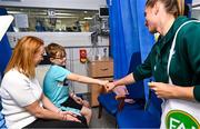 26 June 2023; Jordan Ryan, age 9, and his mum Rachel, from Balbriggan, Dublin, with Republic of Ireland player Chloe Mustaki, during a visit to Temple Street Children's Hospital in Dublin. Photo by Ramsey Cardy/Sportsfile