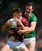 25 June 2023; Paul Conroy of Galway is tackled by Diarmuid O'Connor of Mayo during the GAA Football All-Ireland Senior Championship Preliminary Quarter Final match between Galway and Mayo at Pearse Stadium in Galway. Photo by Brendan Moran/Sportsfile