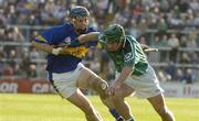 26 June 2004; Andrew O'Shaughnessy, Limerick, is tackled by Martin Maher, Tipperary. Guinness Senior Hurling Championship Qualifier, Round 1, Limerick v Tipperary, Gaelic Grounds, Limerick. Picture credit; Pat Murphy / SPORTSFILE