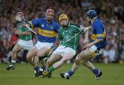 26 June 2004; Niall Moran, Limerick, is tackled by Diarmuid Fitzgerald, left, and Martin Maher, Tipperary. Guinness Senior Hurling Championship Qualifier, Round 1, Limerick v Tipperary, Gaelic Grounds, Limerick. Picture credit; Pat Murphy / SPORTSFILE