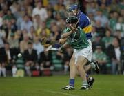 26 June 2004; Seamus Butler, Tipperary, scores his sides third goal despite the attentions of Mickey Cahill, Limerick. Guinness Senior Hurling Championship Qualifier, Round 1, Limerick v Tipperary, Gaelic Grounds, Limerick. Picture credit; Pat Murphy / SPORTSFILE