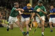 26 June 2004; Lar Corbett, Tipperary, is tackled by Damien Reale, left, and TJ Ryan, Limerick. Guinness Senior Hurling Championship Qualifier, Round 1, Limerick v Tipperary, Gaelic Grounds, Limerick. Picture credit; Pat Murphy / SPORTSFILE