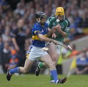 26 June 2004; Niall Moran, Limerick, is tackled by Thomas Dunne, Tipperary. Guinness Senior Hurling Championship Qualifier, Round 1, Limerick v Tipperary, Gaelic Grounds, Limerick. Picture credit; Ray McManus / SPORTSFILE