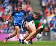 2 July 2023; Jordan Flynn of Mayo is tackled by Dublin goalkeeper Stephen Cluxton as Brian Howard of Dublin looks on during the GAA Football All-Ireland Senior Championship quarter-final match between Dublin and Mayo at Croke Park in Dublin. Photo by John Sheridan/Sportsfile