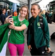 7 July 2023; Katie McCabe poses for a photograph with a supporter at Dublin Airport ahead of the Republic of Ireland's flight to Australia for the FIFA Women's World Cup 2023. Photo by Stephen McCarthy/Sportsfile