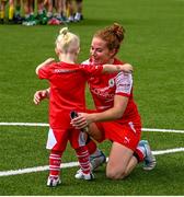 9 July 2023; Marissa Callaghan of Cliftonville celebrates with her son, Quinn, age 3, after her side's victory in the Avenir Sports All-Island Cup semi-final match between Cliftonville and Cork City United at Solitude in Belfast. Photo by Stephen Marken/Sportsfile