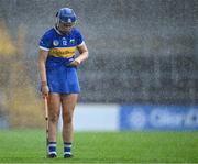22 July 2023; Eimear McGrath of Tipperary dries the ball with her jersey before taking a free during a rain shower in the All-Ireland Camogie Championship semi-final match between Tipperary and Waterford at UPMC Nowlan Park in Kilkenny. Photo by Piaras Ó Mídheach/Sportsfile