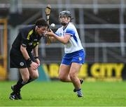 22 July 2023; Abby Flynn of Waterford prepares to pass as referee Liz Dempsey ducks out of the way during the All-Ireland Camogie Championship semi-final match between Tipperary and Waterford at UPMC Nowlan Park in Kilkenny. Photo by Piaras Ó Mídheach/Sportsfile