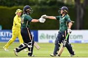 25 July 2023; Amy Hunter of Ireland, right, celebrates with team-mate Laura Delany after bringing up her half century during match two of the Certa Women’s One Day International Challenge between Ireland and Australia at Castle Avenue in Dublin. Photo by Sam Barnes/Sportsfile