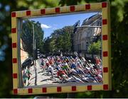 27 July 2023; Cyclists are seen reflected off a traffic mirror in the boys road race final during day four of the 2023 Summer European Youth Olympic Festival in Maribor, Slovenia. Photo by Tyler Miller/Sportsfile