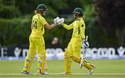 28 July 2023; Australia batter Phoebe Litchfield, right, is congratulated by teammate Annabel Sutherland after bring up her half-century during match three of the Certa Women’s One Day International Challenge series between Ireland and Australia at Castle Avenue Cricket Ground in Dublin. Photo by Seb Daly/Sportsfile