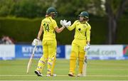 28 July 2023; Australia batters Phoebe Litchfield, right, and Annabel Sutherland celebrate after their side's victory during match three of the Certa Women’s One Day International Challenge series between Ireland and Australia at Castle Avenue Cricket Ground in Dublin. Photo by Seb Daly/Sportsfile