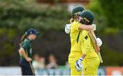 28 July 2023; Phoebe Litchfield of Australia, right, is congratulated by teammate Annabel Sutherland after bringing up her century of runs during match three of the Certa Women’s One Day International Challenge series between Ireland and Australia at Castle Avenue Cricket Ground in Dublin. Photo by Seb Daly/Sportsfile