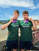 29 July 2023; Conor Murphy of Team Ireland, left, with his time trial Silver medal and teammate Cian Crampton with his discus Bronze medal on the Old Bridge in Maribor during day six of the 2023 Summer European Youth Olympic Festival at in Maribor, Slovenia. Photo by Tyler Miller/Sportsfile