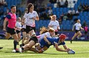 19 August 2023; Usha Daly-O'Toole of Leinster scores her side's fourth try despite the tackle of Niamh Barrett of Ulster during the Girl’s Interprovincial Championship match between Leinster and Ulster at Energia Park in Dublin. Photo by Ben McShane/Sportsfile