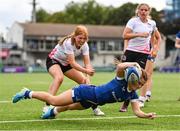 19 August 2023; Emma Brogan of Leinster is tackled by Erin McConalogue of Ulster on her way to scoring her side's fifth try during the Girl’s Interprovincial Championship match between Leinster and Ulster at Energia Park in Dublin. Photo by Ben McShane/Sportsfile