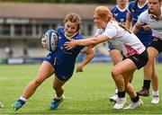 19 August 2023; Emma Brogan of Leinster is tackled by Erin McConalogue of Ulster on her way to scoring her side's fifth try during the Girl’s Interprovincial Championship match between Leinster and Ulster at Energia Park in Dublin. Photo by Ben McShane/Sportsfile