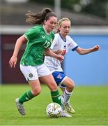 22 August 2023; Leah McGrath of Republic of Ireland in action against Sára Kristiansen of Faroe Islands during a women's U16 international friendly match between Republic of Ireland and Faroe Islands at Head in the Game Park in Drogheda, Louth. Photo by Ben McShane/Sportsfile